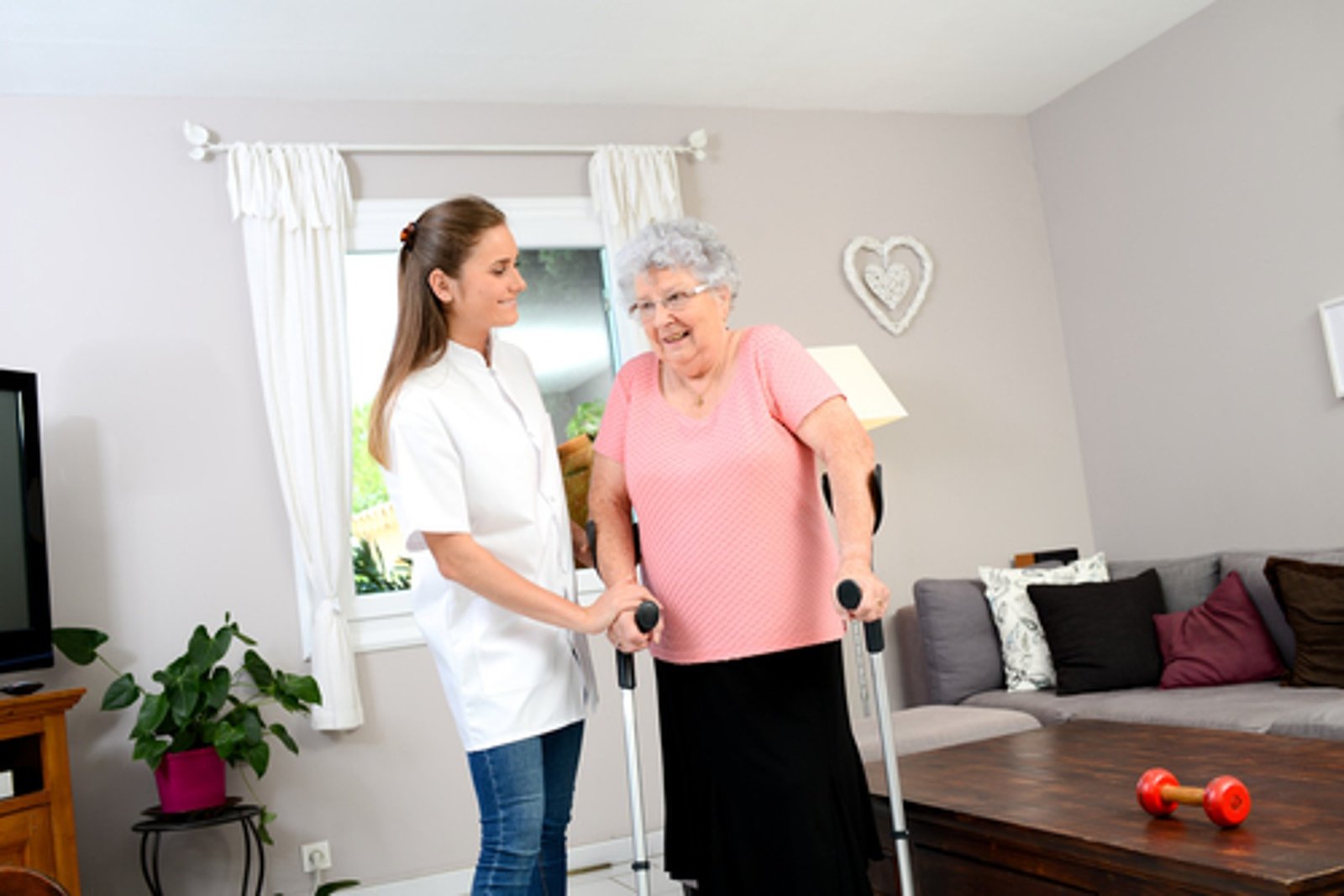 Caregiver helping client with mobility and rehabilitation